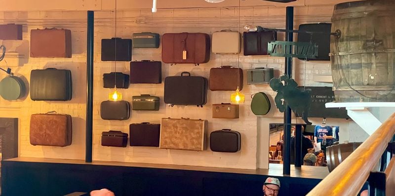 Suitcases hang on the wall of Porter Beer Bar in Atlanta's Little Five Points neighborhood.  / Courtesy of Angela Hansberger