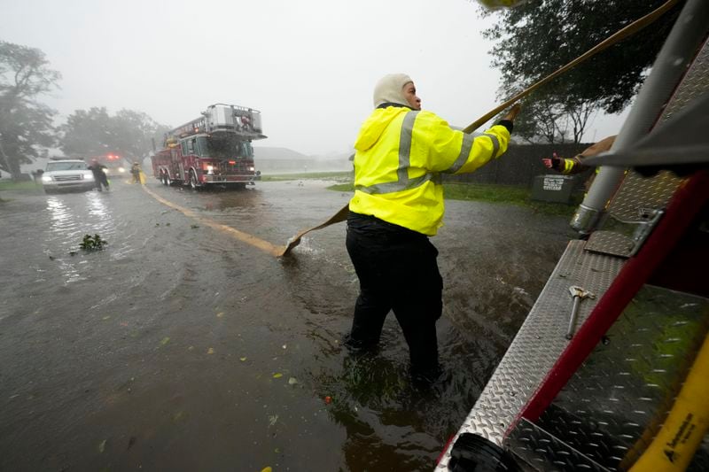 Morgan City firefighters respond to a home fire during Hurricane Francine in Morgan City, La., Wednesday, Sept. 11, 2024. (AP Photo/Gerald Herbert)