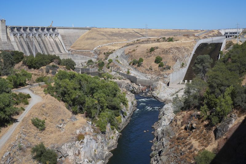 The American River flows out of the Folsom Dam, Friday, Aug. 16, 2024, in Folsom, Calif. (AP Photo/Godofredo A. Vásquez)