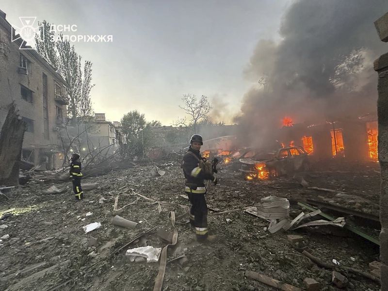 In this photo provided by the Ukrainian Emergency Service, firefighters put out the fire after Russia attacked the city with guided bombs overnight in Zaporizhzhia, Ukraine, Sunday, Sept. 29, 2024. (Ukrainian Emergency Service via AP)