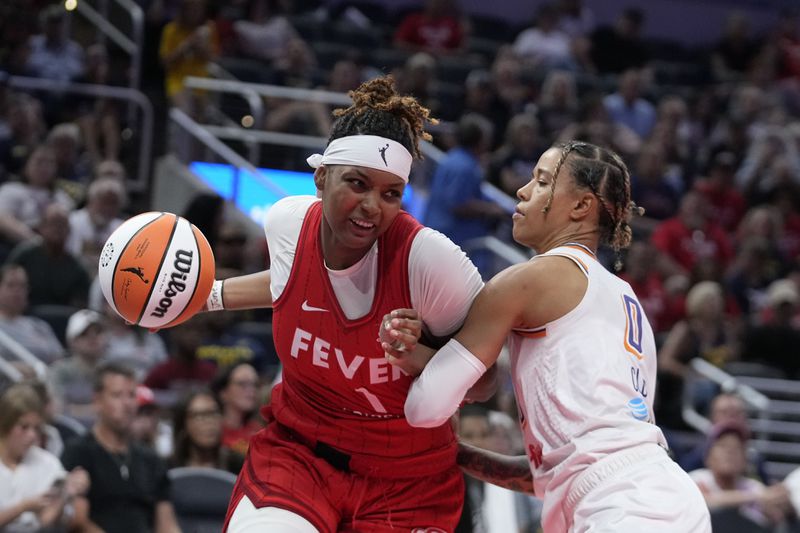 Indiana Fever forward NaLyssa Smith (1) goes to the basket against Phoenix Mercury's Natasha Cloud (0) during the second half of a WNBA basketball game, Friday, Aug. 16, 2024, in Indianapolis. (AP Photo/Darron Cummings)