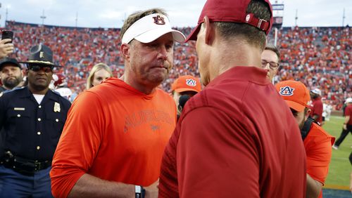 Auburn head coach Hugh Freeze, left, and Oklahoma head coach Brent Venables, right, meet at midfield after the second half of an NCAA college football game, Saturday, Sept. 28, 2024, in Auburn, Ala. (AP Photo/Butch Dill)