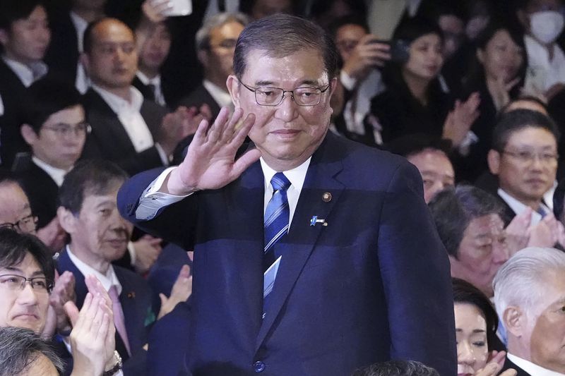 Shigeru Ishiba, center, waves as he is elected as leader of the ruling Liberal Democratic Party after the party's leadership election, in Tokyo Friday, Sept. 27, 2024. (Kyodo News via AP)