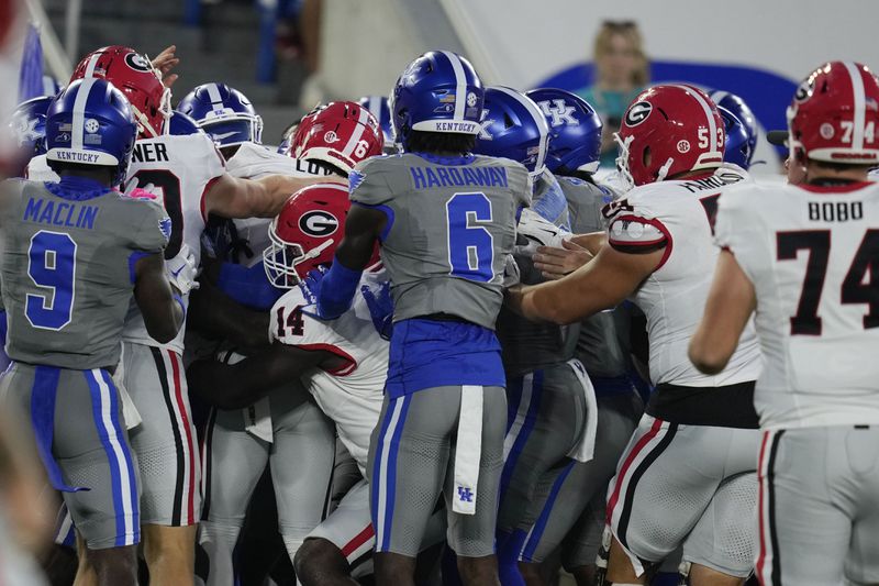 Players from Georgia and Kentucky shove each other during the first half of an NCAA college football game, Saturday, Sept. 14, 2024, in Lexington, Ky. (AP Photo/Darron Cummings)