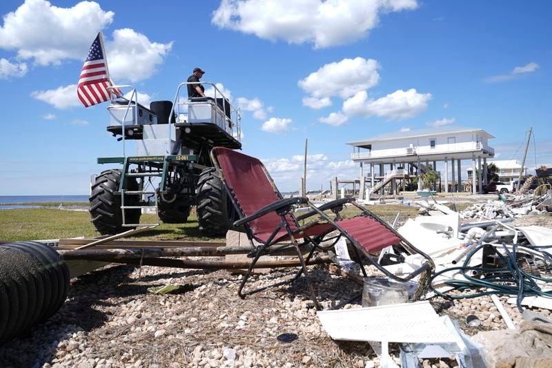 Security detail looks on as President Joe Biden greets people in Keaton Beach, Fla., Thursday, Oct. 3, 2024, during his tour of areas impacted by Hurricane Helene. (AP Photo/Susan Walsh)