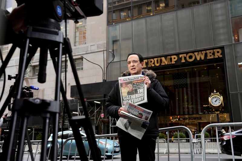 A reporter holds a copy of the New York Post with the headline “The Gathering Stormy” outside Trump Tower a day after a grand jury voted to indict former President Donald Trump in Manhattan, March 31, 2023. A Manhattan grand jury voted to indict Trump on Thursday afternoon, and he is likely to be arraigned on Tuesday, when the charges against him will be formally unveiled. (Todd Heisler/The New York Times)
                      