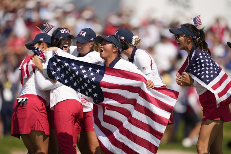 United States players celebrate after winning the Solheim Cup golf tournament at the Robert Trent Jones Golf Club, Sunday, Sept. 15, 2024, in Gainesville, Va. (AP Photo/Matt York)