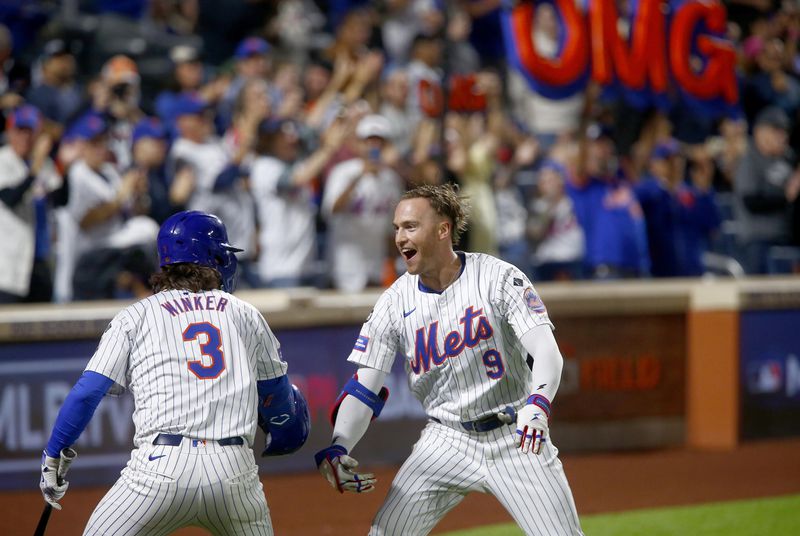 New York Mets' Jesse Winker, left, and Brandon Nimmo celebrate Nimmo's home run in the sixth inning during a baseball game Sunday, Sept. 22, 2024, in New York. (AP Photo/John Munson)