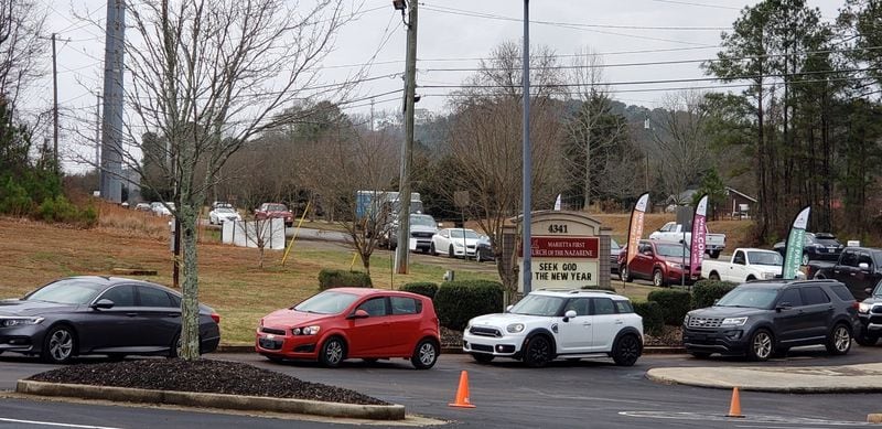 At 1 p.m. Wednesday, the line was long for COVID-19 testing at Marietta First Church of the Nazarene on Dallas Highway. (Shelia Poole/AJC)