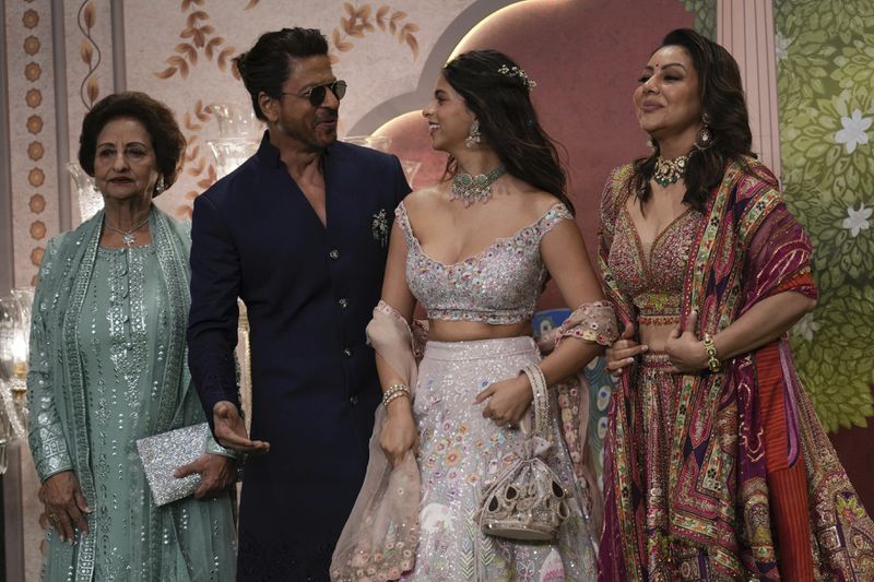 Indian actor Shahrukh Khan, second left, shares a light moment with his family as they pose for a picture during the blessing ceremony of newlywed couple Anant Ambani son of billionaire Mukesh Ambani's and his wife Radhika Merchant at Jio World Convention Centre in Mumbai, India, Saturday, July. 13, 2024. (AP Photo /Rajanish Kakade)