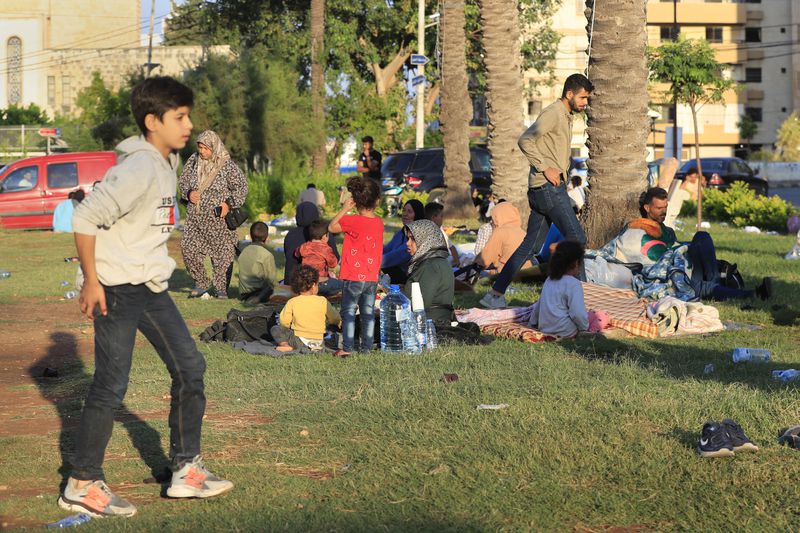 Lebanese citizens who fled the southern villages amid ongoing Israeli airstrikes Monday, settle at a public park in the southern port city of Sidon, Lebanon, Tuesday, Sept. 24, 2024. (AP Photo/Mohammed Zaatari)