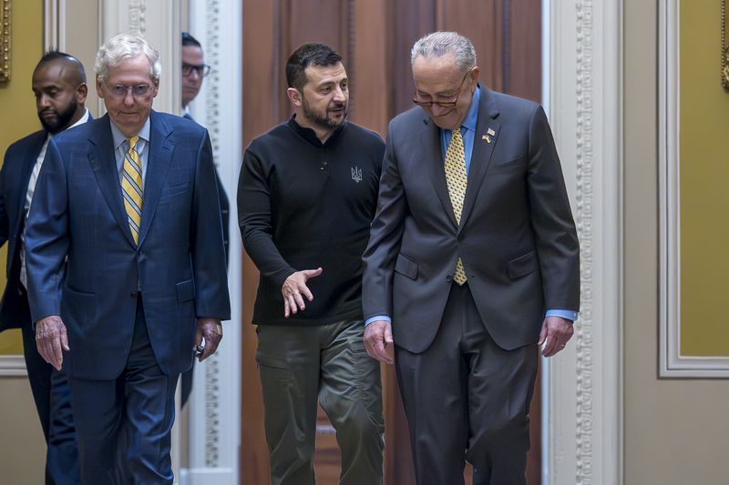 Ukrainian President Volodymyr Zelenskyy (center) walks with Republican Senate Minority Leader Mitch McConnell (left) and Democratic Senate Majority Leader Chuck Schumer (right) at the Capitol in Washington on Thursday.