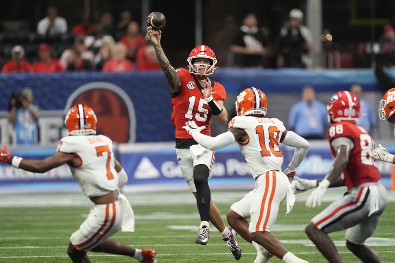 Georgia quarterback Carson Beck (15) throws a pass during the first half of an NCAA college football game against Clemson Aug. 31, 2024, in Atlanta. (AP Photo/John Bazemore)