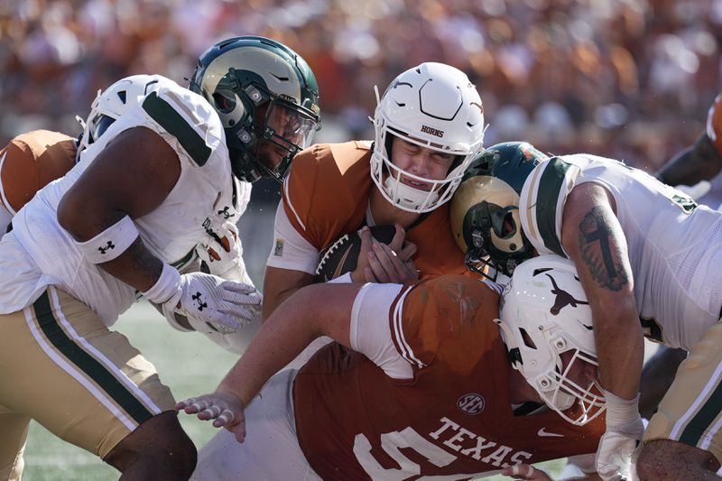 Texas quarterback Arch Manning, center, scores a touchdown against Colorado State on a keeper during the second half of an NCAA college football game in Austin, Texas, Saturday, Aug. 31, 2024. (AP Photo/Eric Gay)