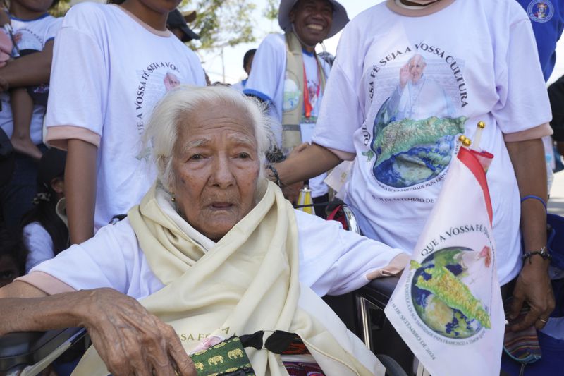 People wait Pope Francis' arrival outside of the Dili Presidente Nicolau Lobato International Airport in Dili, East Timor, Monday, Sept. 9, 2024. (AP Photo/Firdia Lisnawati)