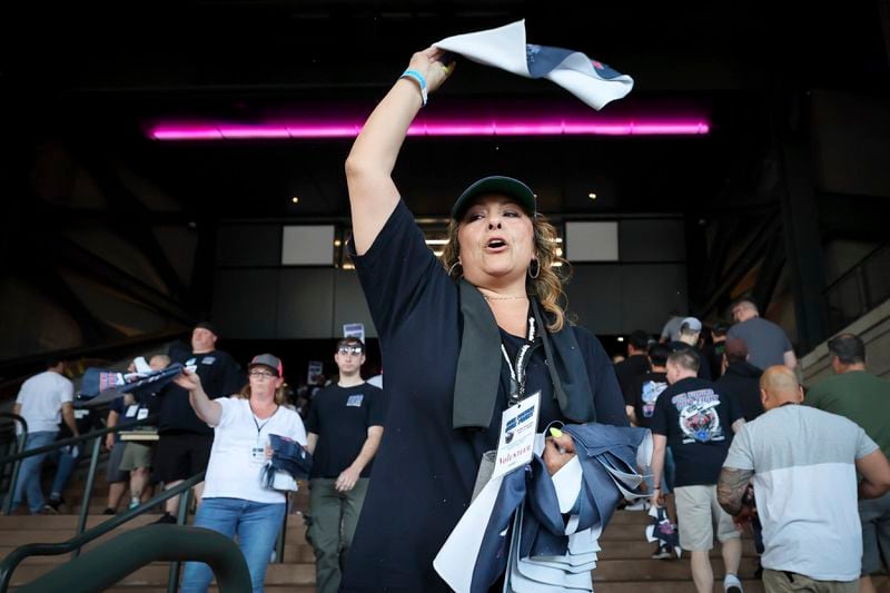 FILE - Cristina Green waves a towel to machinists and fellow union members for a "stop work meeting" and strike sanction at T-Mobile Park in Seattle, July 17, 2024. (Kevin Clark/The Seattle Times via AP, File)