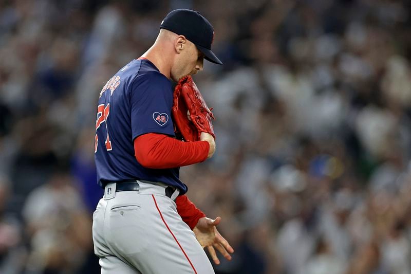 Boston Red Sox relief pitcher Cam Booser reacts after giving up a grand slam to New York Yankees' Aaron Judge during the seventh inning of a baseball game Friday, Sept. 13, 2024, in New York. (AP Photo/Adam Hunger)