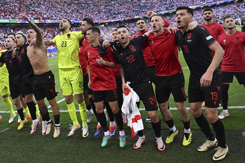 Albania's players celebrate after a Group B match between Croatia and Albania at the Euro 2024 soccer tournament in Hamburg, Germany, Wednesday, June 19, 2024. (Sina Schuldt/dpa via AP)