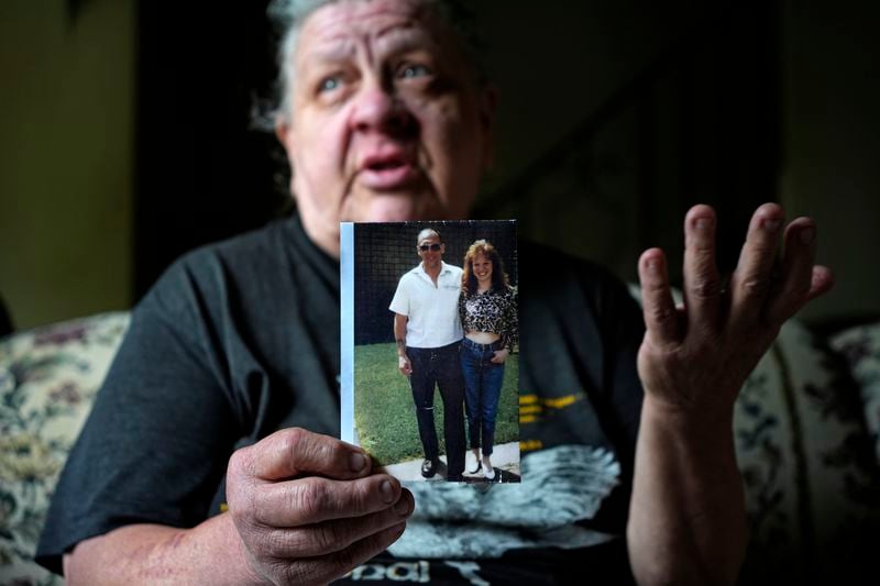 Suzy Patton holds a photo of her brother Steve Szarewicz, who insists he was wrongly convicted of a 1981 murder based on the testimony of four jailhouse informants, in her home in New Kensington, Pa, on Tuesday, April 30, 2024. (AP Photo/Gene J. Puskar)