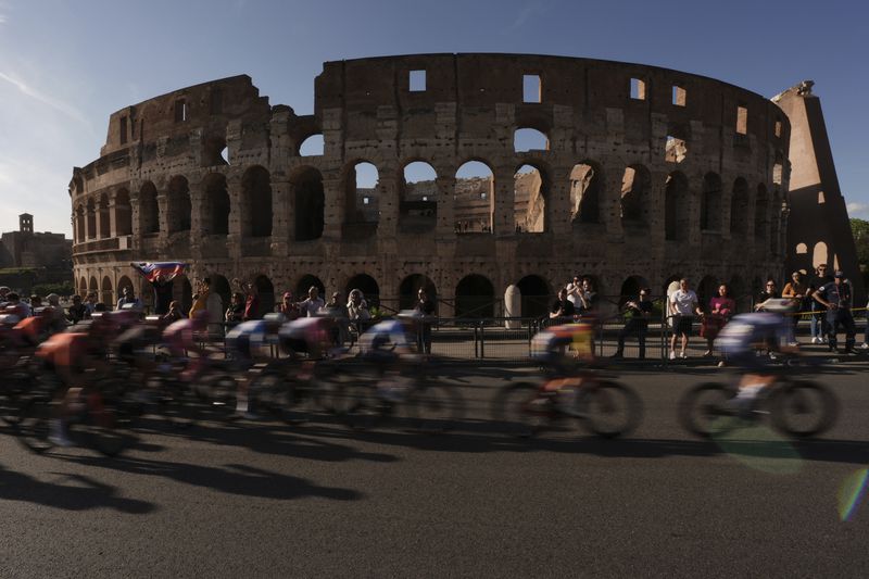 Cyclists ride past the ancient Colosseum during the final stage of the Giro d’Italia cycling race in Rome, Sunday, May 26, 2024. (Massimo Paolone/LaPresse via AP)