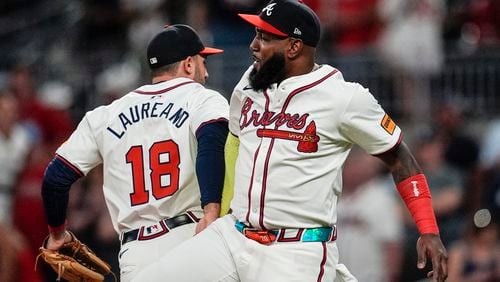 Atlanta Braves' Ramón Laureano (18) and Marcell Ozuna (20) celebrate a win after a baseball game against the Philadelphia Phillies, Tuesday, Aug. 20, 2024, in Atlanta. (AP Photo/Mike Stewart)