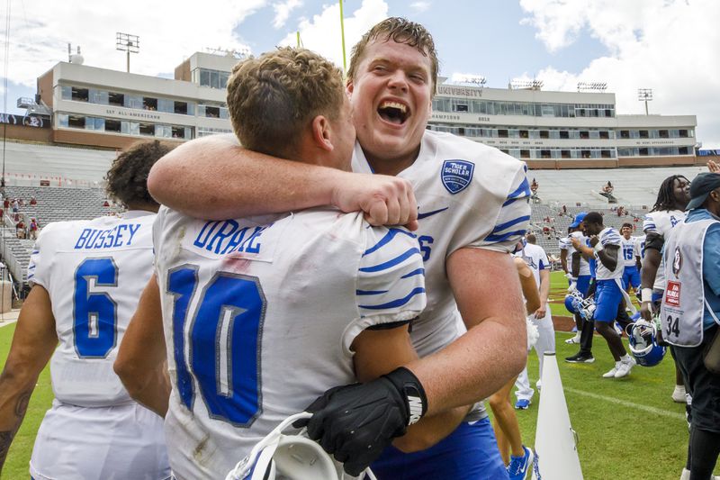 Memphis wide receiver Koby Drake (10) and offensive lineman Jonah Gambill (65) celebrate after defeating Florida State 20-14 in a NCAA college football game, Saturday, Sept. 14, 2024, in Tallahassee, Fla. (AP Photo/Colin Hackley)