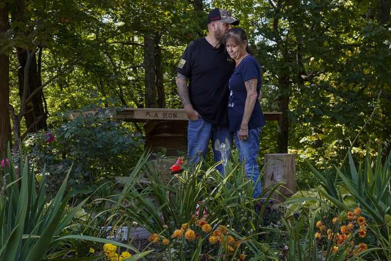 FILE - Brian and Karen Goodwin stand for a portrait near a memorial for motorcycle riders that includes the name of her son, Austin Hunter Turner, along U.S. Highway 421, Friday, Sept. 22, 2023, in Shady Valley, Tenn. (AP Photo/George Walker IV, File)