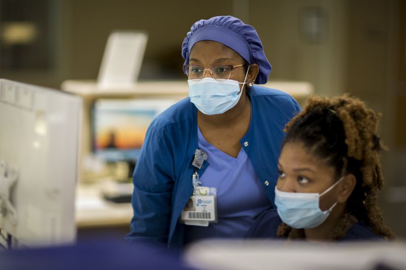 Emanuel Medical Center nurses Dorsie Smith, left, and Cece Tayor review a patient's information on a monitor at the ICU.
 (AJC Photo/Stephen B. Morton)