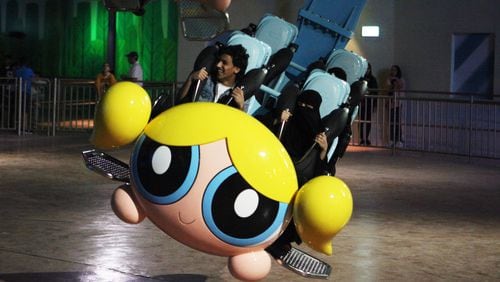 People shout as they experience the Powerpuff Girls - Mojo Jojo’s Robot Rampage ride at the IMG Worlds of Adventure amusement park in Dubai, United Arab Emirates, on Wednesday, Aug. 31, 2016. The IMG Worlds of Adventure indoor theme park opened Wednesday in Dubai, hoping to draw thrill seekers to its air-conditioned confines. (AP Photo/Jon Gambrell)