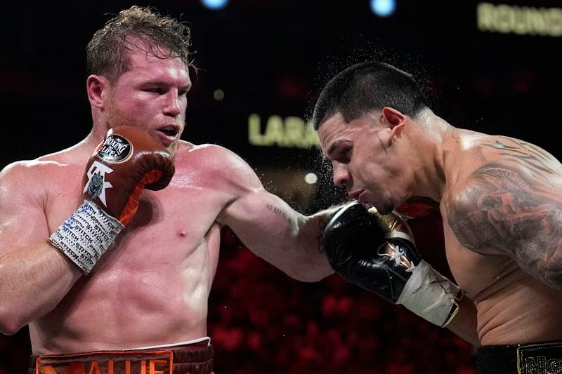 Canelo Alvarez hits Edgar Berlanga in a super middleweight title bout Saturday, Sept. 14, 2024, in Las Vegas. (AP Photo/John Locher)