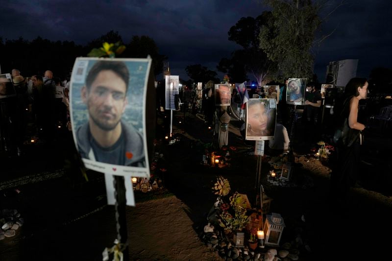 People visit the site of the Nova music festival, where hundreds of revelers were killed and abducted by Hamas and taken into Gaza, on the one-year anniversary of the attack, near Kibbutz Reim, southern Israel, Monday, Oct. 7, 2024. (AP Photo/Ariel Shalit)