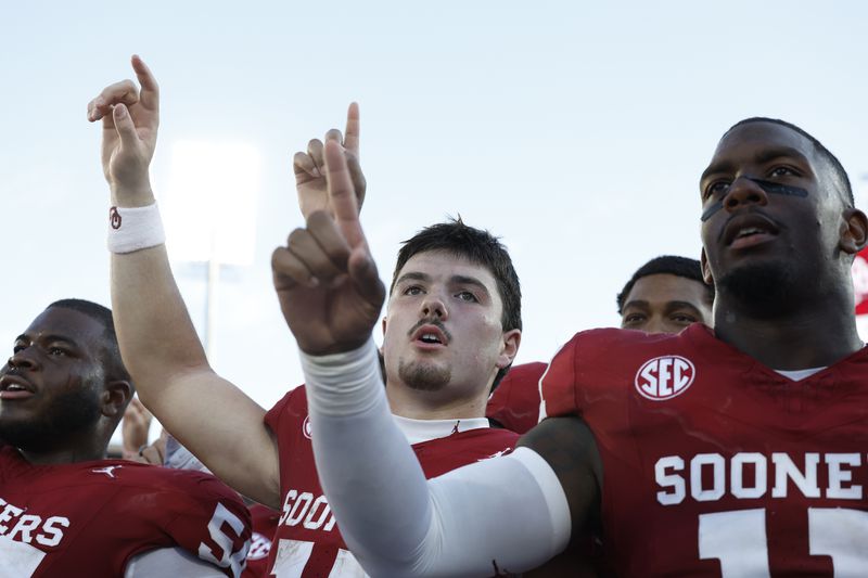 Oklahoma quarterback Jackson Arnold and linebacker Kobie McKinzie sing the school song after they defeated Tulane during an NCAA college football game, Saturday, Sept. 14, 2024, in Norman, Okla. (AP Photo/Alonzo Adams)