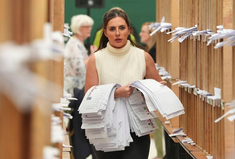 Count staff sort ballots at Nemo Rangers GAA club for the local and European Parliament elections, in Cork, Ireland, Sunday June 9, 2024. (Jonathan Brady/PA via AP)