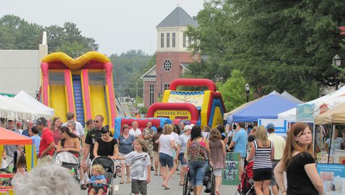 Visitors peruse antiques and handcrafted arts around the Historic Marietta Square for Marietta StreetFest.