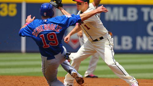 The Cubs' Nate Schierholtz is out attempting to steal second as Braves Tyler Pastornicky awaits the throw during the second inning of their MLB game on Sunday, May 11, 2014, in Atlanta. CURTIS COMPTON / CCOMPTON@AJC.COM