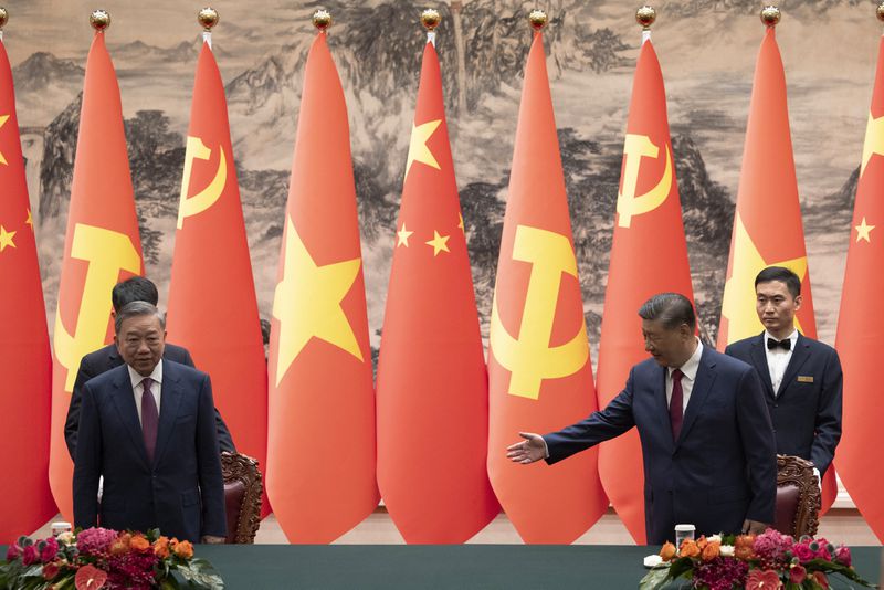 Chinese President Xi Jinping, front right, and Vietnam's President To Lam, front left, arrive for a signing ceremony at the Great Hall of the People in Beijing Monday, Aug. 19, 2024. (Andres Martinez Casares/Pool Photo via AP)