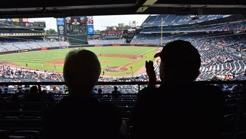 Braves fans Seaton and Lucille Smith (foreground) cheer during Atlanta Braves home game against the San Francisco Giants at Turner Field on Thursday, June 2, 2016.