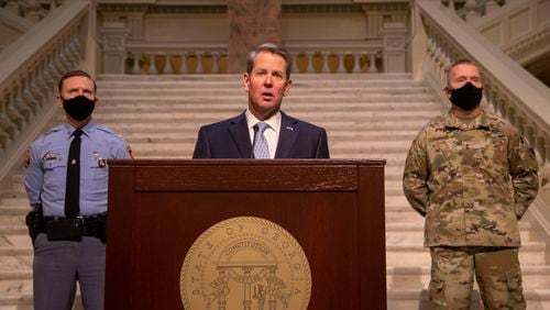 Gov. Brian Kemp makes remarks about security at the Georgia State Capitol building with Colonel Chris C. Wright (left), Commissioner of the Department of Public Safety, and Adjutant General Thomas Carden (right), of the Georgia Department of Defense, during a press conference about vaccine distribution at the Georgia State Capitol building in Atlanta, Tuesday, Jan. 12, 2021. (Alyssa Pointer / Alyssa.Pointer@ajc.com)