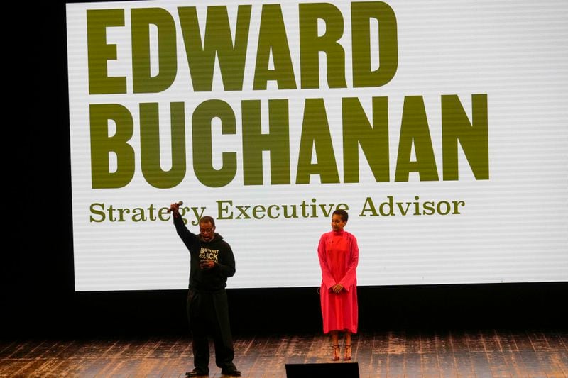 Strategy Executive Advisor Edward Buchanan gestures flanked by Tamu McPherson walks on the stage during the Afro Fashion Association second edition of the 'Black carpet awards' in Milan, Italy, Friday, Sept. 20, 2024. (AP Photo/Luca Bruno).