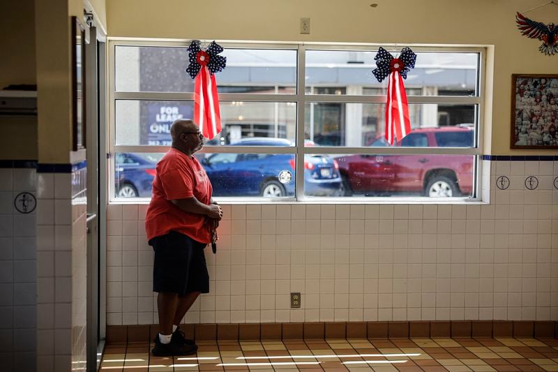 A man waits for his order inside a restaurant Wednesday, June 19, 2024, in downtown Racine, Wis. (AP Photo/Jeffrey Phelps)