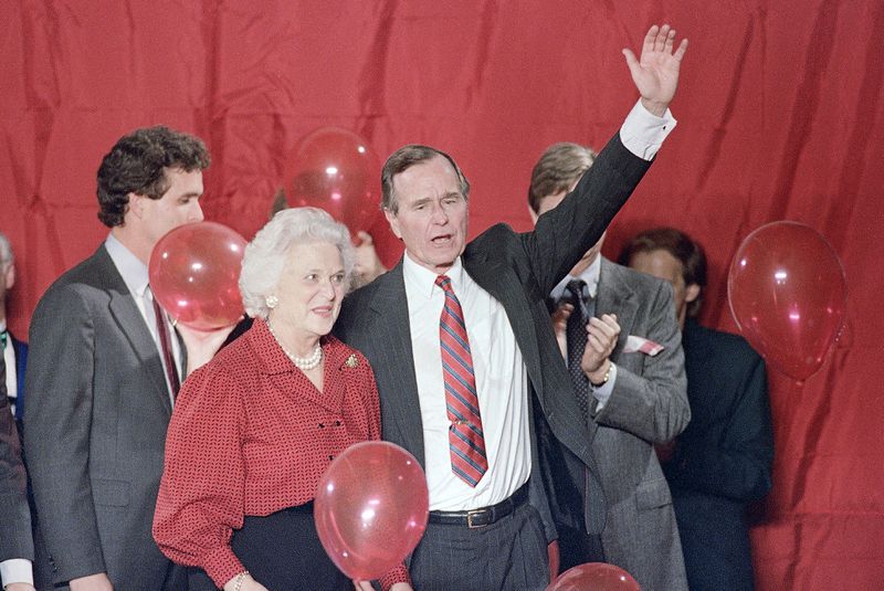 FILE - Vice President George H.W. Bush and Barbara Bush wave as balloons are dropped during a welcome rally in Houston, Nov. 8, 1988. (AP Photo/John Duricka, File)