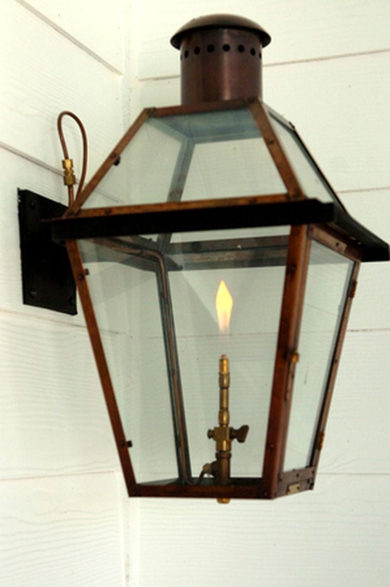 Details like this gas lantern make the large front porch a favorite aspect of the house. Their front door was also custom designed.