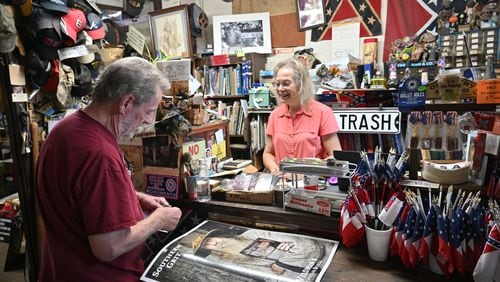 June 16, 2022 Kennesaw - Marjorie Lyon (right), the new owner, helps a longtime customer Mickey Magruder at Wildman's Civil War Surplus in Kennesaw on Thursday, June 16, 2022. The store first opened in downtown Kennesaw in 1971. When the owner, Dent Myers died in January, Marjorie Lyon vowed to keep the shop open. Councilman James “Doc” Eaton resigned from Kennesaw City Council Tuesday over the reopening of Wildman’s Civil War shop. (Hyosub Shin / Hyosub.Shin@ajc.com)