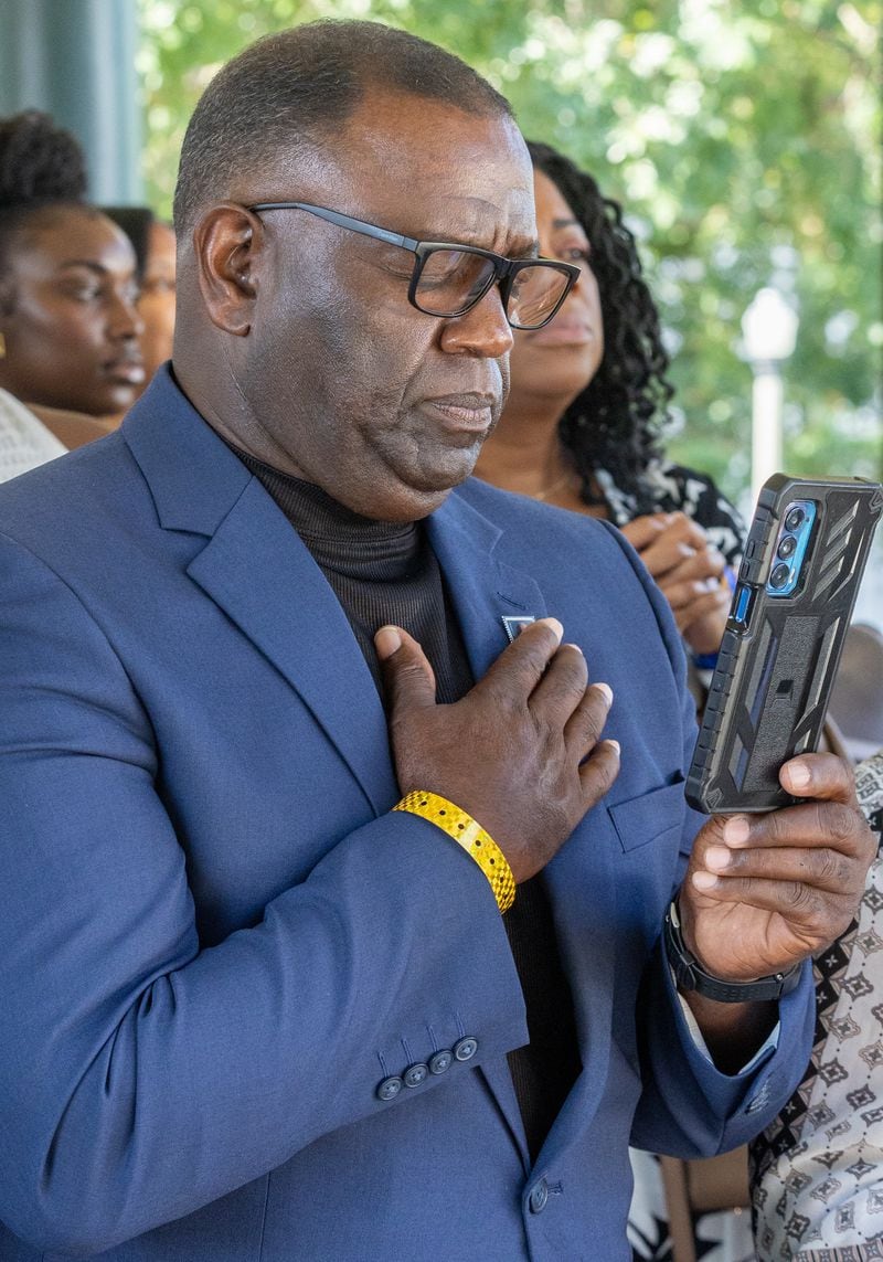 Henry Grant Lewis, the brother of John Lewis, documents the statue unveiling ceremony memorial honoring the late Congressman in Decatur on Saturday, Aug 24, 2024. (Steve Schaefer / AJC)