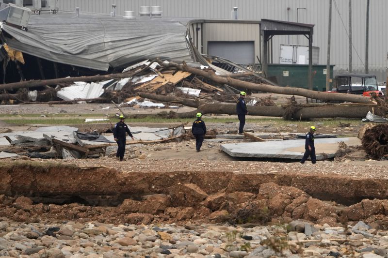 Personnel from Urban Search and Rescue Utah Task Force 1 work in the aftermath of Hurricane Helene Friday, Oct. 4, 2024, in Erwin, Tenn. (AP Photo/Jeff Roberson)