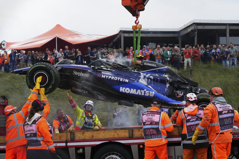 The car of Williams driver Logan Sargeant of the US is lifted after a crash during the third free practice ahead of the Formula One Dutch Grand Prix race at the Zandvoort racetrack, Netherlands, Saturday, Aug. 24, 2024. (AP Photo/Peter Dejong)