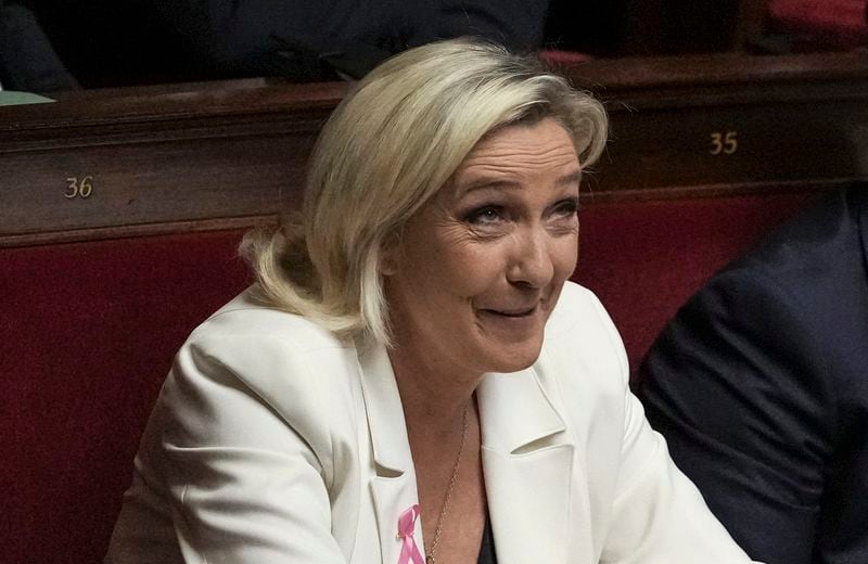 French far-right leader Marine Le Pen reacts during the speech of Prime Minister Michel Barnier at the National Assembly, in Paris, Tuesday, Oct. 1, 2024. (AP Photo/Thibault Camus)