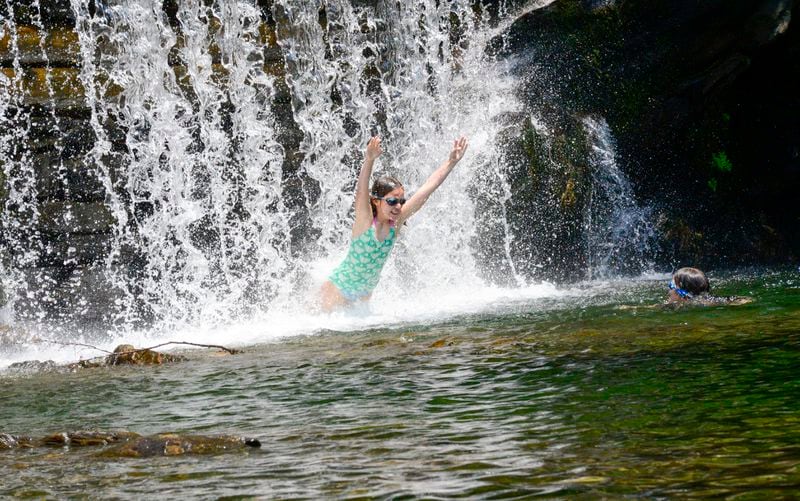 Finoa Murdie, 10, jumps through the water at the Green River Timber Crib Dam in Guilford, Vt., on Wednesday, June 19, 2024. (Kristopher Radder /The Brattleboro Reformer via AP)