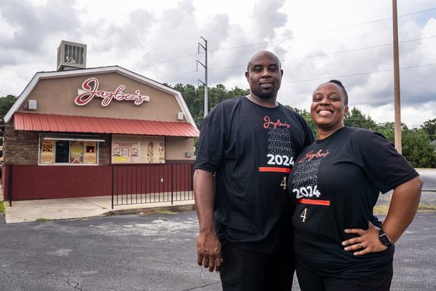 Jaybee’s Tenders co-founders Erika Harrington and her husband William Harrington pose for a portrait outside the restaurant in Decatur, GA on Thursday, July 25, 2024. (Seeger Gray / AJC)
