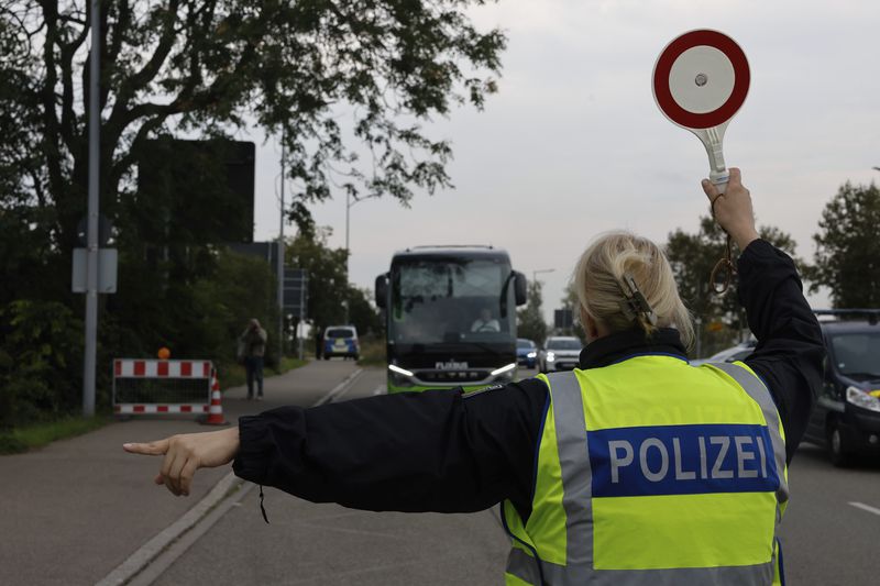 German police officers stop a bus at the border between Germany and France in Kehl, Germany, Monday, Sept. 16, 2024 as Germany controls all his borders from Monday on. (AP Photo/Jean-Francois Badias)